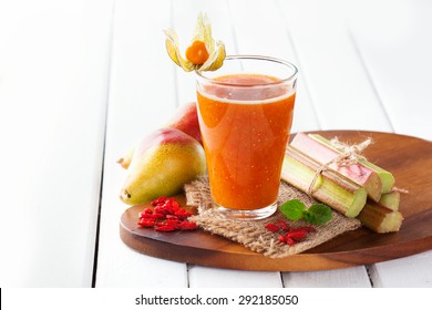 Fresh organic fruit smoothie in a glass with ingredients on rustic white wooden background, selective focus - Powered by Shutterstock