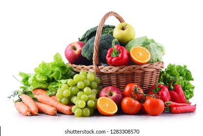 Fresh organic fruits and vegetables in wicker basket isolated on white - Shutterstock ID 1283308570