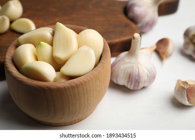 Fresh organic garlic on white table, closeup