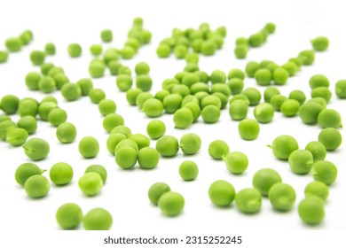 Fresh organic green peas scattered on a white background. - Shutterstock ID 2315252245