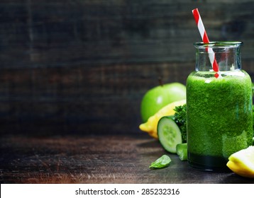 Fresh organic green smoothie with spinach, cucumber, parsley, celery and lemon on wooden background - Powered by Shutterstock