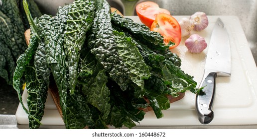 Fresh Organic Kale Leaves on Wooden Cutting Board with Knife - Powered by Shutterstock