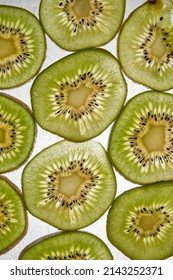 Fresh Organic Kiwi Fruit Sliced. Green Kiwi Circles Background. Line Up. Kiwi Pattern. Flay Lay. Top View.