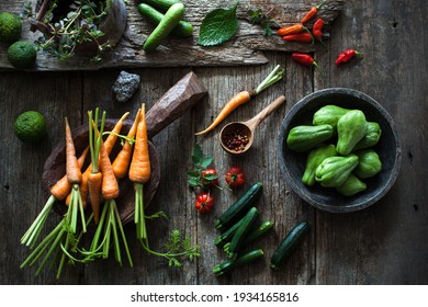 Fresh and organic local produced of various raw vegetables, looks so colourful on the wooden rustic table. moody light. - Shutterstock ID 1934165816