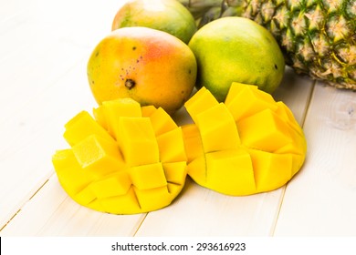Fresh Organic Mango And Pineapple On A White Wood Board.