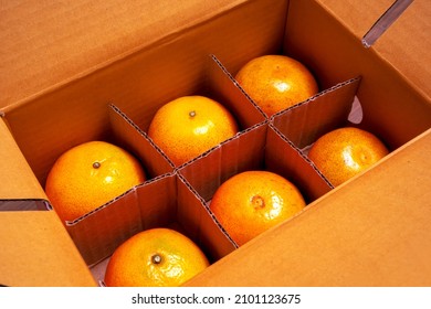 Fresh organic oranges from farm delivered in carton paper packaging box.