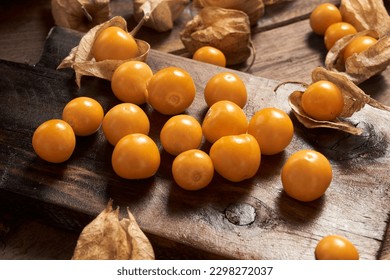 Fresh organic physalis fruit ,Helathy fresh Gooseberry Cape ,Uchuva delicious tropical fruit in Peru, Cape gooseberry (Physalis peruviana) plant on wooden background                   - Powered by Shutterstock