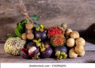 Fresh organic rambutan mangosteen Longan custard apple and Wollongong fruit fruit in thailand on wooden table.