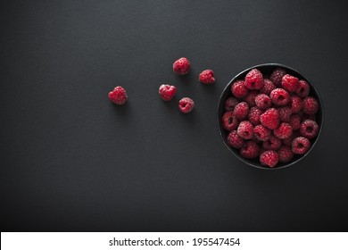 Fresh organic raspberries on black background