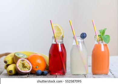 Fresh organic raw unpasteurised fruit vegetable juice smoothie pressed glass bottle on rustic wooden wood table diet healthy life living sport urban cafe
