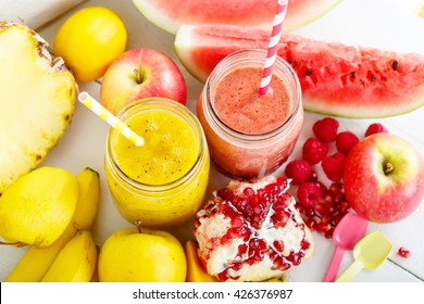 Fresh Organic Red And Yellow Smoothie With Apple, Watermelon, Pomegranate, Raspberry, Pineapple, Banana And Mango. Healthy, Vegan Drinks.