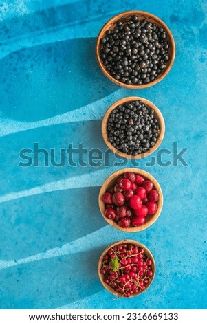 Fresh organic summer berries mix on blue concrete  background. Blueberries, red black currant and cherries. Top view. Concept of summer food. Flat lay, copy space Foto stock © 