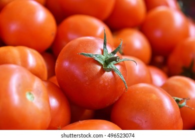 Fresh organic tomatoes on street market stall.