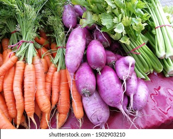 fresh organic vegetables - celery, Daikon radish, bunch of carrots in the farmer's market in Richmond, British Columbia, Canada