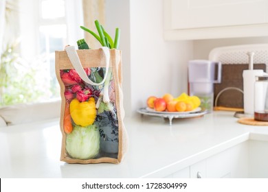 Fresh Organic Vegetables Delivery Concept. Reusable Bio Eco Sackcloth Fabric Bag Packaging On Marble White Kitchen Table. Local Farmer Healthy Food. Zero Waste And Plastic-free Lifestyle. Copy Space