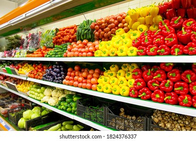 Fresh organic Vegetables and fruits on shelf in supermarket, farmers market. Healthy food market concept. Vitamins and minerals in vegetables and fruits. Fresh vegetables tomatoes, capsicum, cucumbers