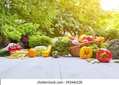 Fresh Organic Vegetables And Fruits On Wood Table In The Garden 