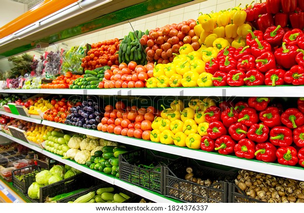 Fresh organic Vegetables and fruits on shelf in\
supermarket, farmers market. Healthy food market concept. Vitamins\
and minerals in vegetables and fruits. Fresh vegetables tomatoes,\
capsicum, cucumbers