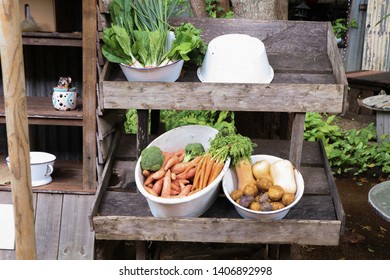 Fresh Organic Vegetables On A Rustic Wooden Shelf. Sweet Potato, Broccoli, Carrots, Potato And Pumpkin In Bowls Straight From A Farm.