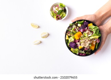 Fresh Organic Vegetables Salad With Quinoa Seed In Bowl Holding By Hand On White Background, Healthy Vegan Food, Top View