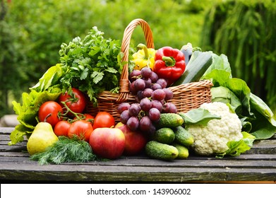 Fresh Organic Vegetables In Wicker Basket In The Garden