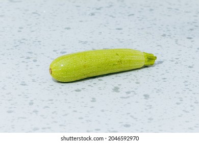 Fresh Organic Whole Zucchini On A White Marble Kitchen Worktop