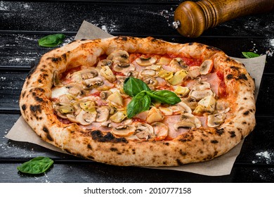 Fresh original Italian pizza with mushrooms and ham from the traditional wood-fired stone oven.