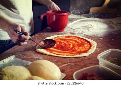 Fresh original Italian raw pizza, preparation in traditional style. 