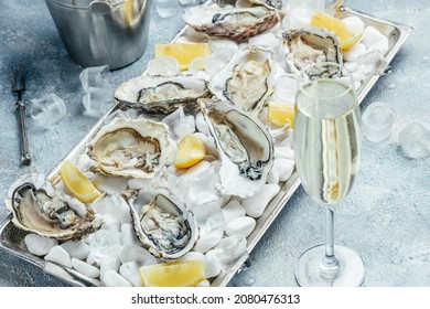 Fresh oyster in dish with lemon and champagne in restaurant. banner, menu, recipe place for text, top view.