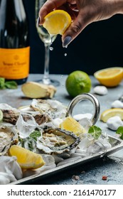 Fresh oysters with lemon and ice. Restaurant delicacy. oysters dish. Oyster dinner with champagne in restaurant, banner, menu, recipe place for text, top view, - Shutterstock ID 2161470177
