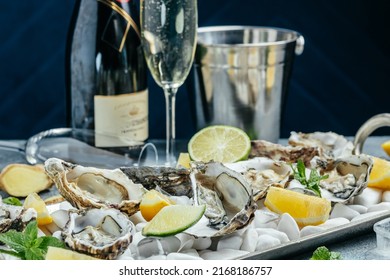 Fresh oysters with lemon and ice. Restaurant delicacy. oysters dish. Oyster dinner with champagne in restaurant, banner, menu, recipe place for text, top view, - Shutterstock ID 2168186757