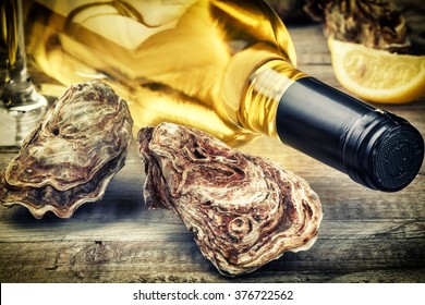Fresh oysters with white wine bottle. Food background