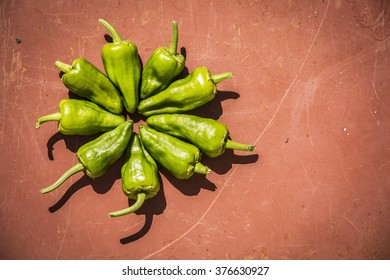 Fresh Padron Chilli over a rustic table - circle