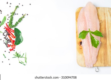 Fresh Pangasius Dory Or Basa Fish Fillet With Ingredient Herb On White Isolated