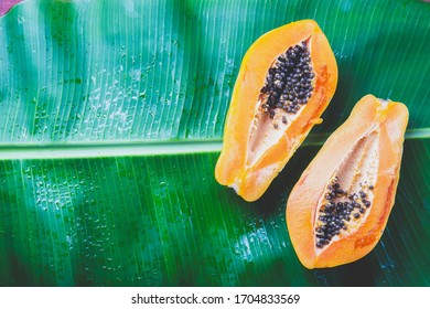 Fresh Papaya On Banan Tree Leaves Background. Tropical Concept.