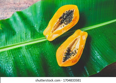 Fresh Papaya On Banan Tree Leaves Background. Tropical Concept.