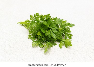 Fresh parsley on the table. Parsley leaves. Natural vitamins. A green bunch of parsley on the home table close-up. Healthy eating. Healthy food. - Powered by Shutterstock