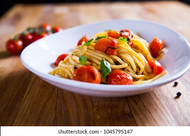 Fresh pasta with garlic Cherry Tomatoes and basil. Deliciosu  Pasta Plate. Raw vegan pasta. Spaghetti. Italian food. Italy. Roma. Fine dining. Healthy food. Fresca Pasta. Vegetarian - Powered by Shutterstock