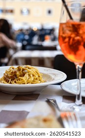  Fresh pasta   spaghetti cacio e pepe and Aperol Spritz  at  typical italian resaturant at Trastevere   neighbourhood at Rome 