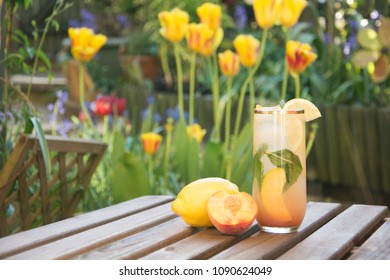 Fresh Peach Ice Tea Outside In A Flower Garden