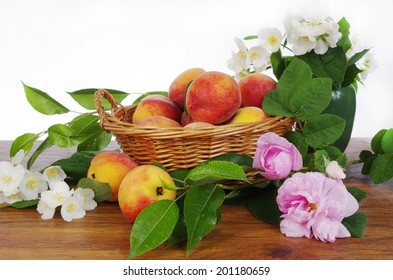 Fresh peaches and flowers in basket