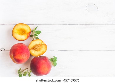 Fresh peaches on wooden white background. Top view, flat lay, copy space