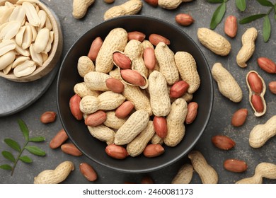 Fresh peanuts and twigs on grey table, flat lay