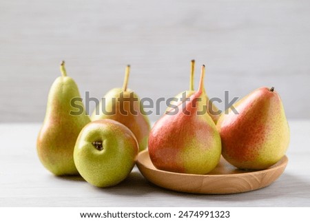 Fresh pear fruit on wooden plate with white table, Healthy fruit