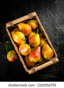 Fresh pears in a basket. On a black background. High quality photo