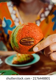 A Fresh Pecan Cookie, Food, And Snacks.Close-up Shot Woman's Hand Holding A Pecan Cookie With Blurred Body On The Background.