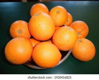 Fresh Picked Navel Oranges, In A Silver Bowl On Green Countertop.