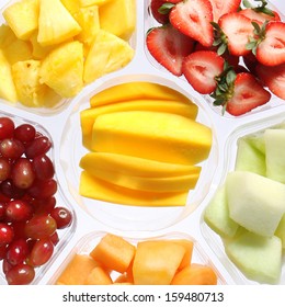 Fresh Pieces Of Fruits In Plastic Container. Healthy Food. Different Kinds Of Sliced Fruits: Mango, Strawberries, Melon, Grapes, Pineapple.