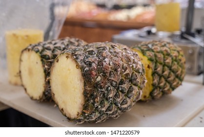 Fresh Pinapple Being Cut To Sell At Grocery Store.