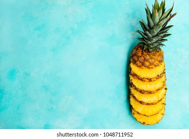 Fresh Pineapple Slices On Blue Background. Top View. Copy Space.